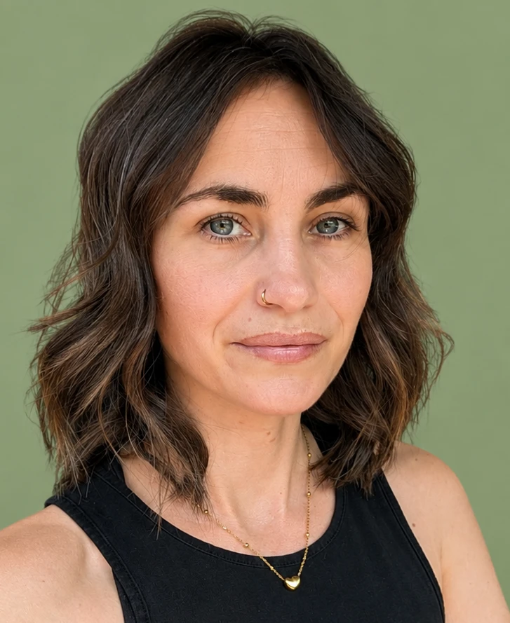 Krista Barton, the reflexologist behind Holistic Heelin', photographed against a soft green background.